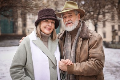 Photo of Portrait of happy senior couple on winter day