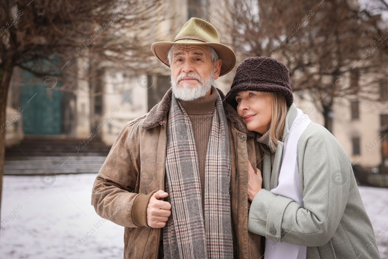 Photo of Portrait of senior couple on city street. Space for text