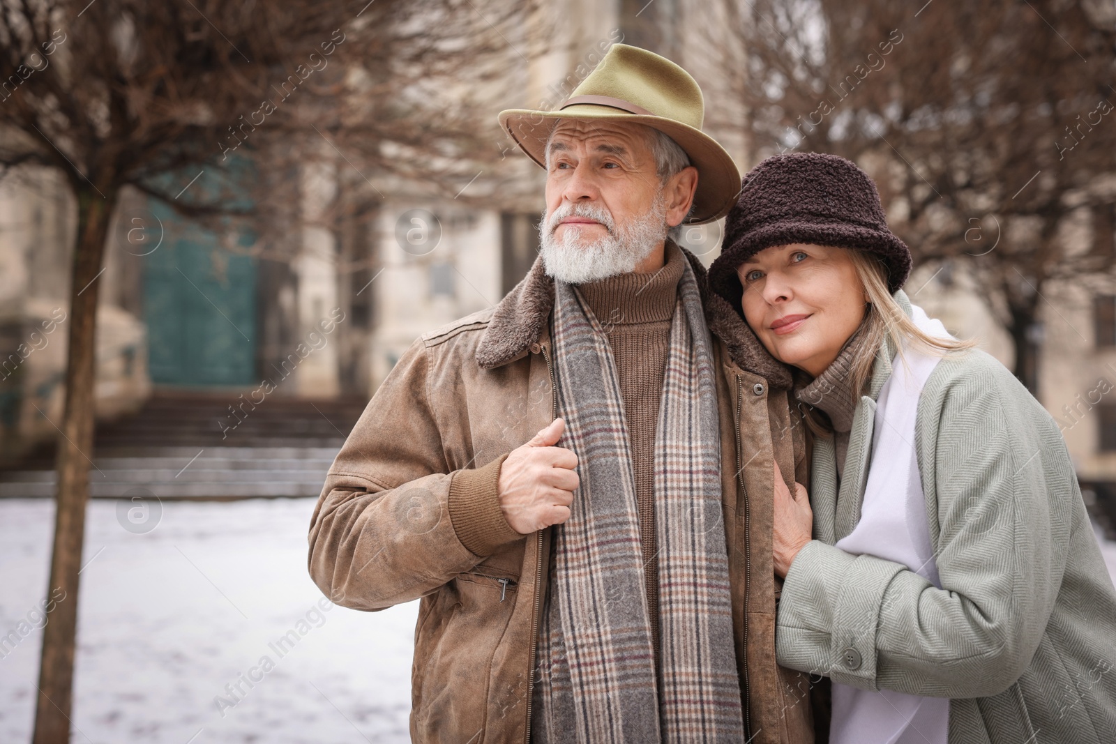 Photo of Portrait of senior couple on city street. Space for text