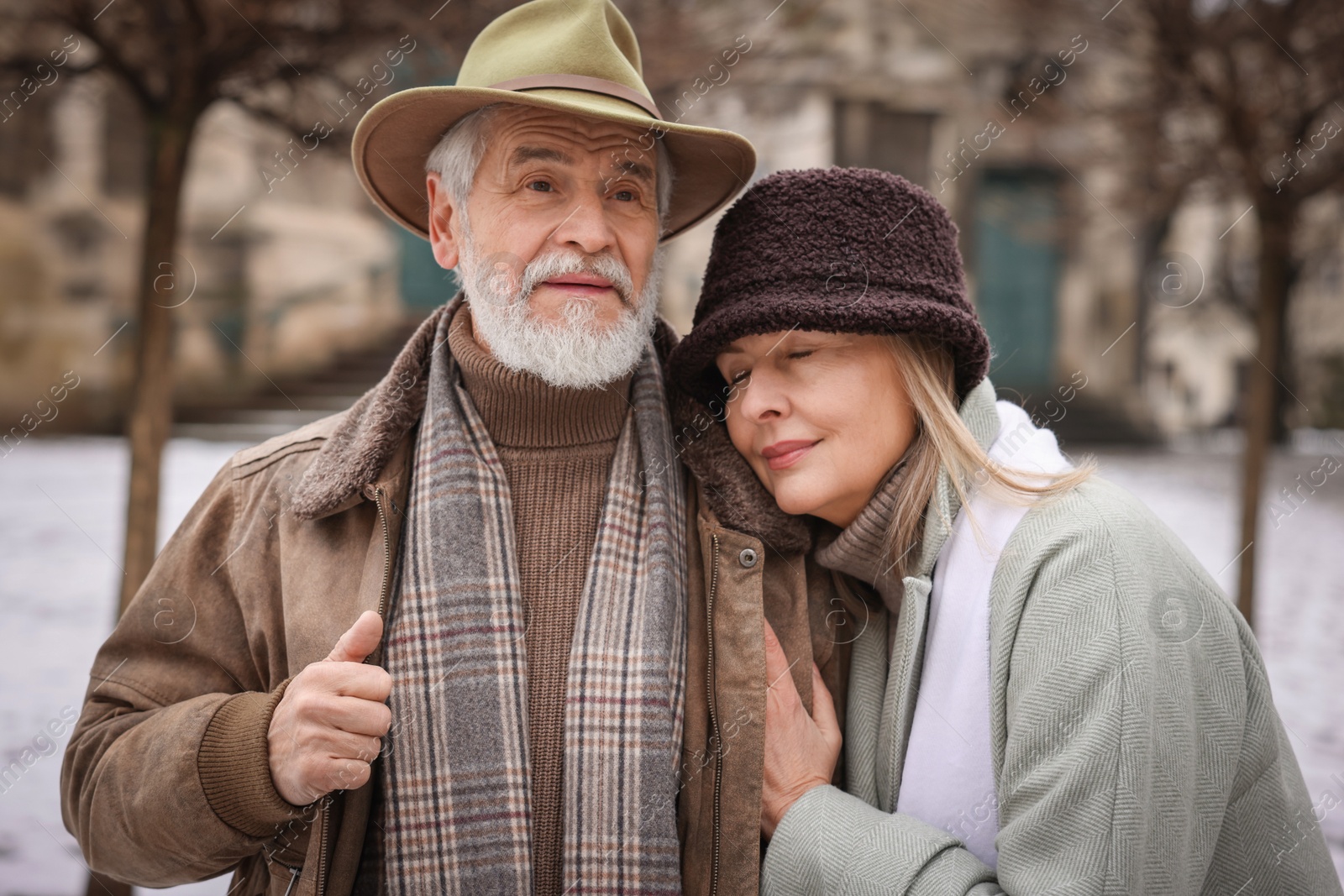 Photo of Lovely senior couple walking on city street