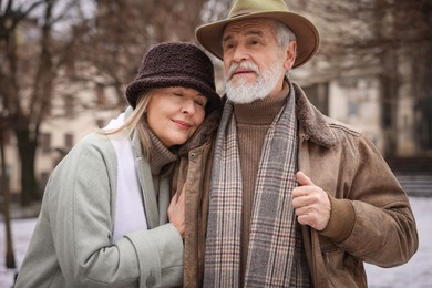 Photo of Lovely senior couple walking on city street