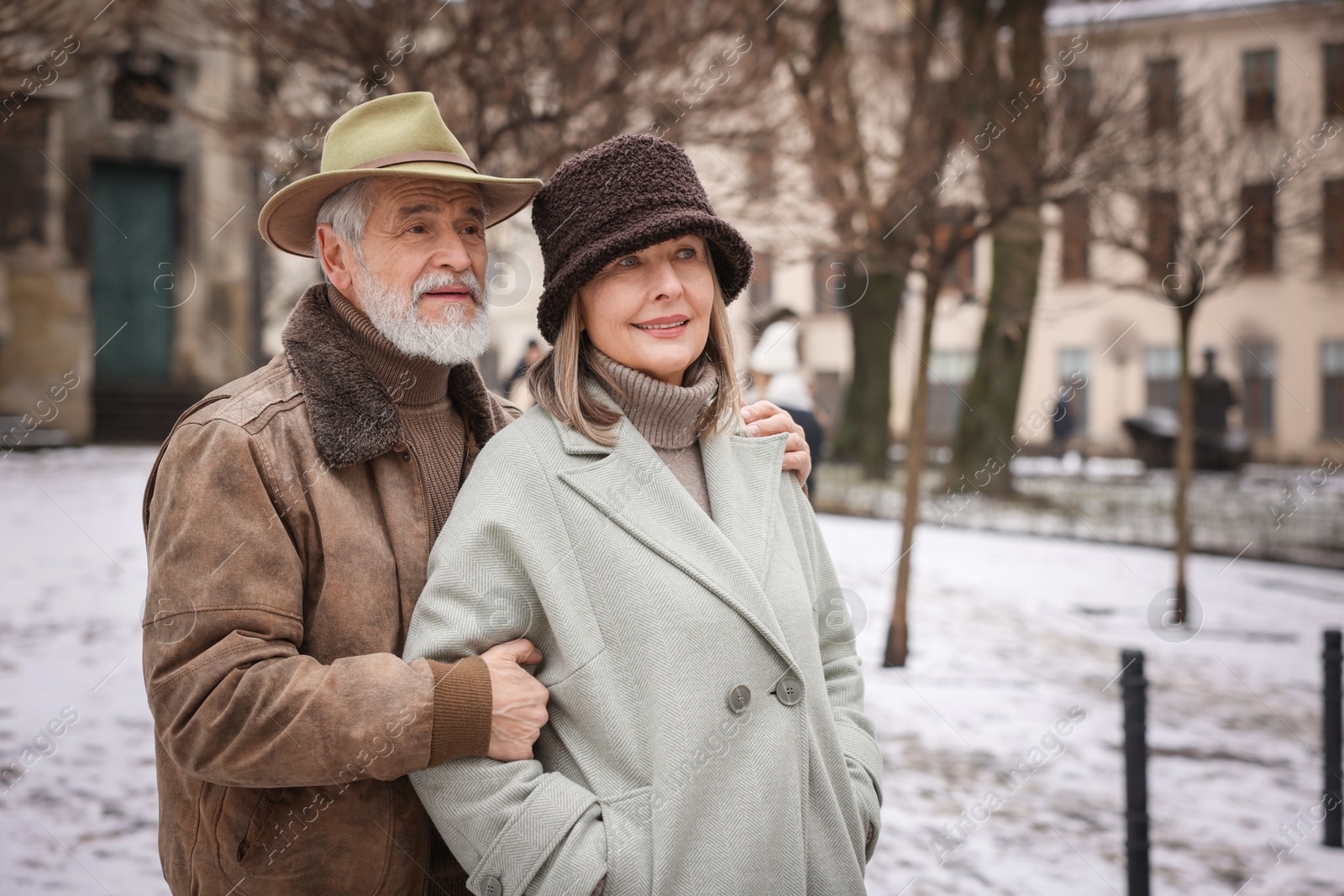 Photo of Portrait of senior couple on city street. Space for text