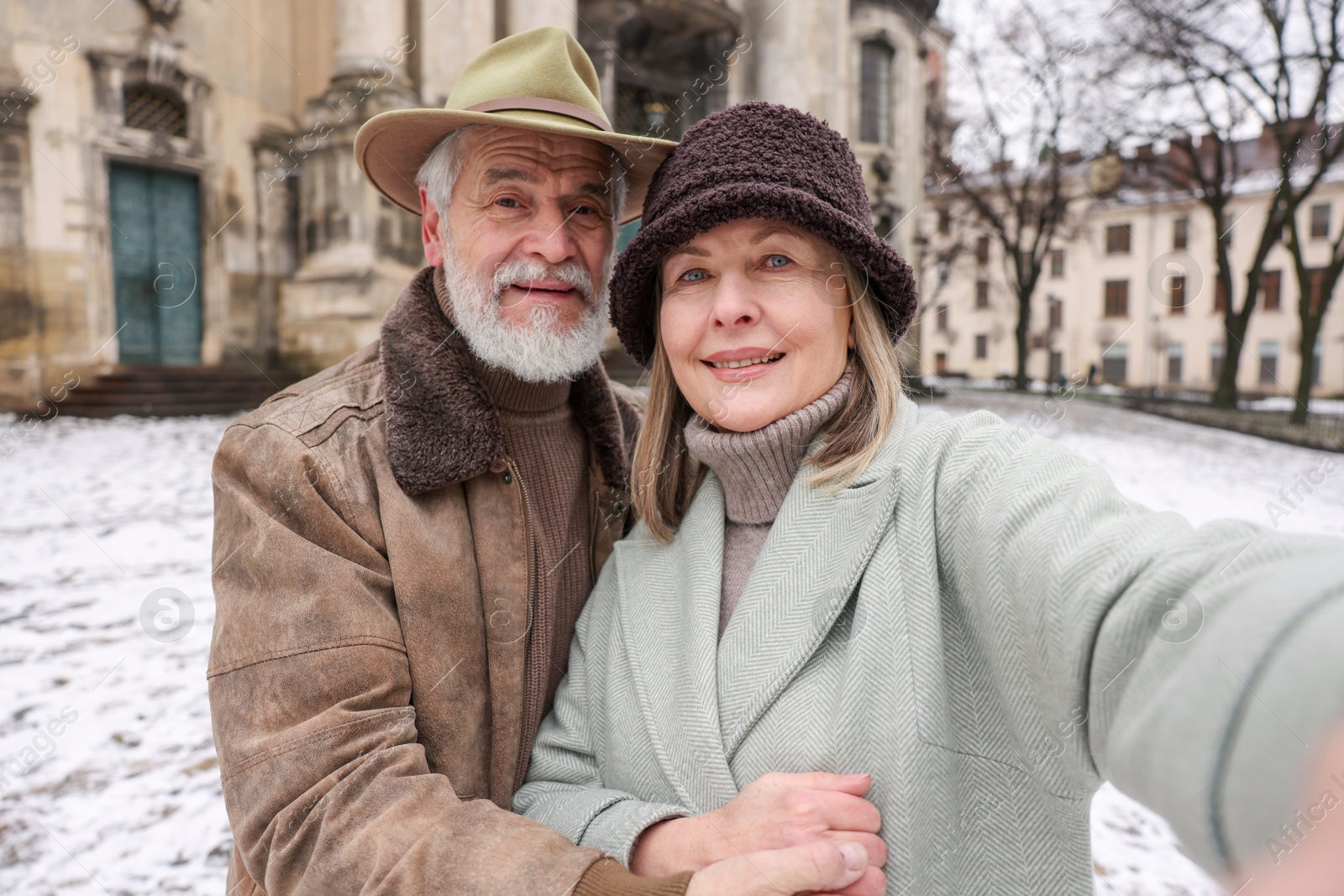 Photo of Happy senior couple taking selfie on winter day