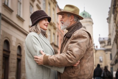 Photo of Happy senior couple walking on city street