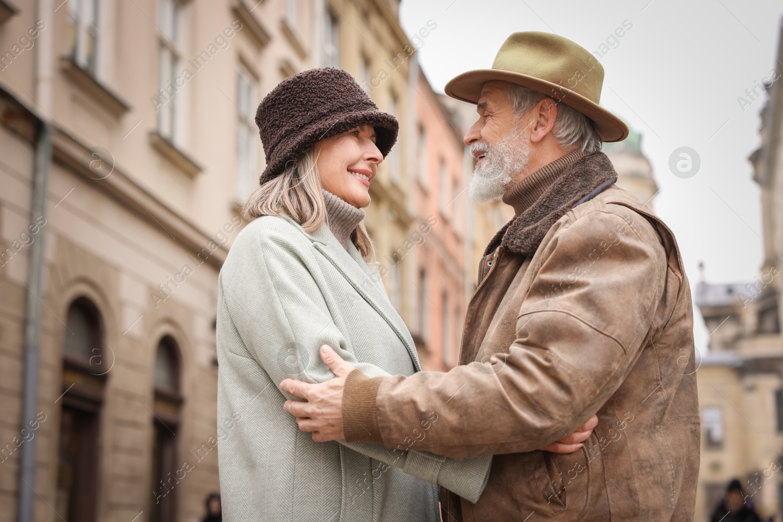 Photo of Happy senior couple walking on city street