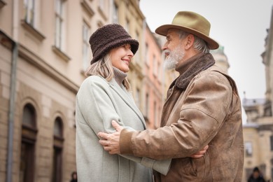 Photo of Happy senior couple walking on city street