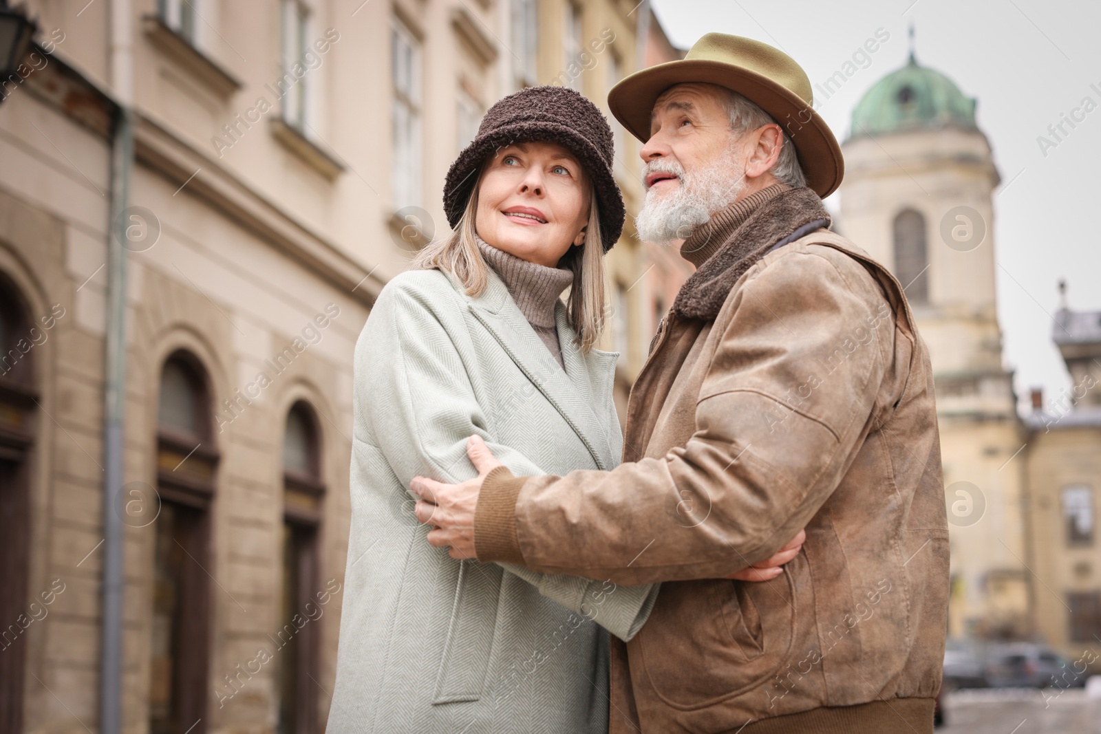 Photo of Lovely senior couple on city street. Space for text