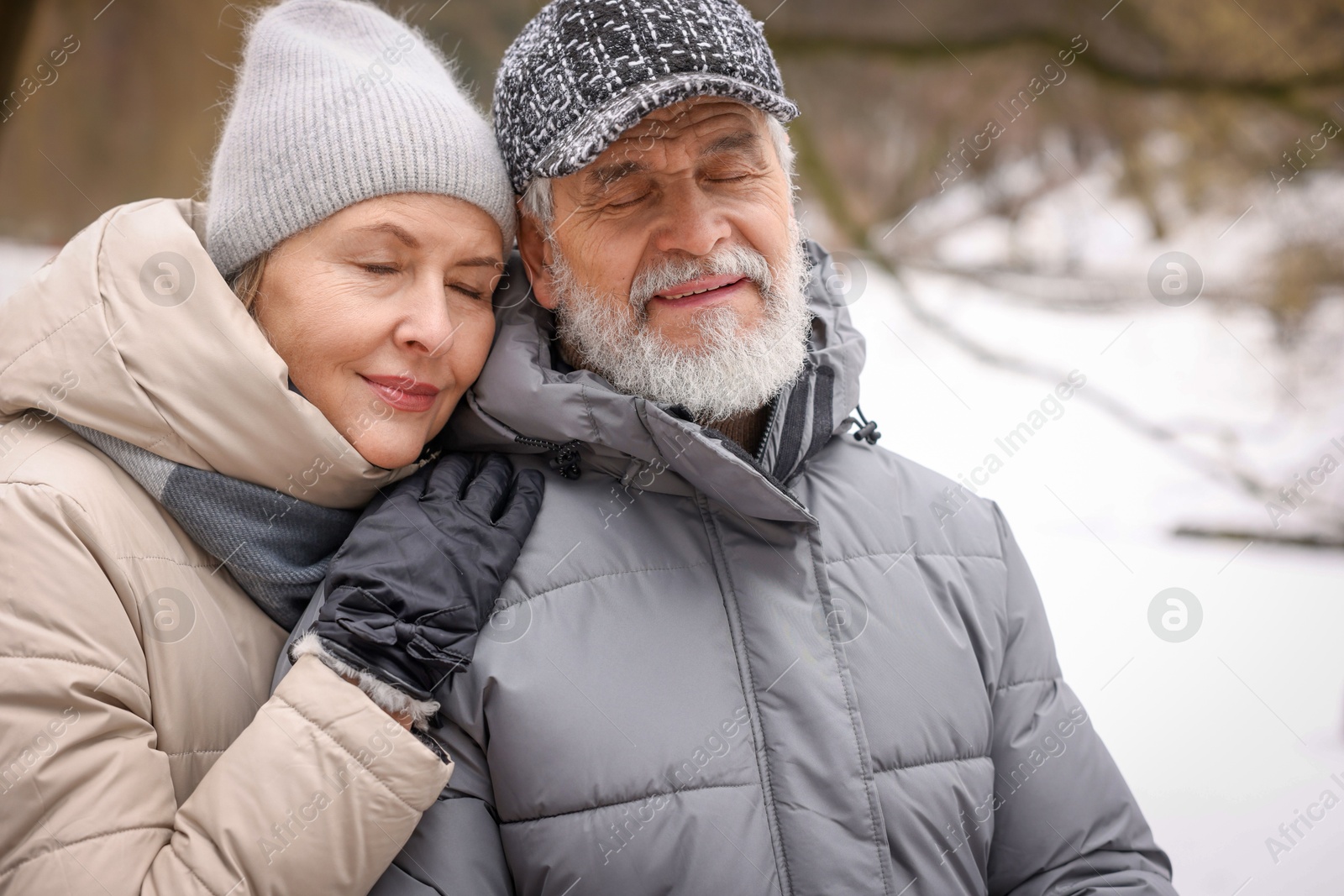 Photo of Lovely senior couple at winter park. Space for text