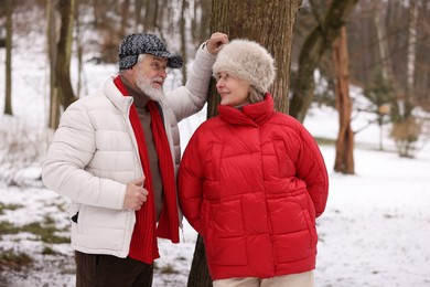 Photo of Lovely senior couple spending time together in winter park