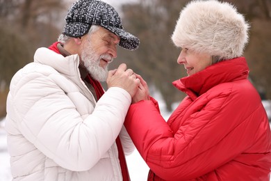 Photo of Lovely senior couple holding hands in park