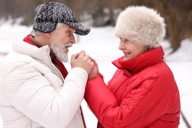 Photo of Lovely senior couple holding hands in park