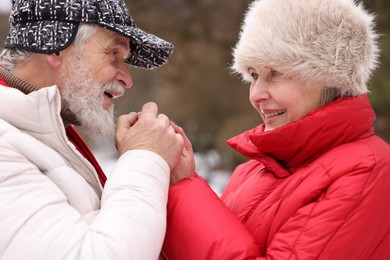 Photo of Lovely senior couple holding hands in park