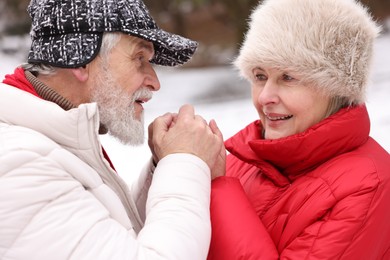 Photo of Lovely senior couple holding hands in park