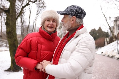 Photo of Lovely senior couple having fun on city street