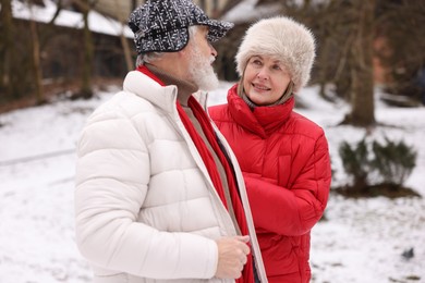 Photo of Lovely senior couple walking at winter park