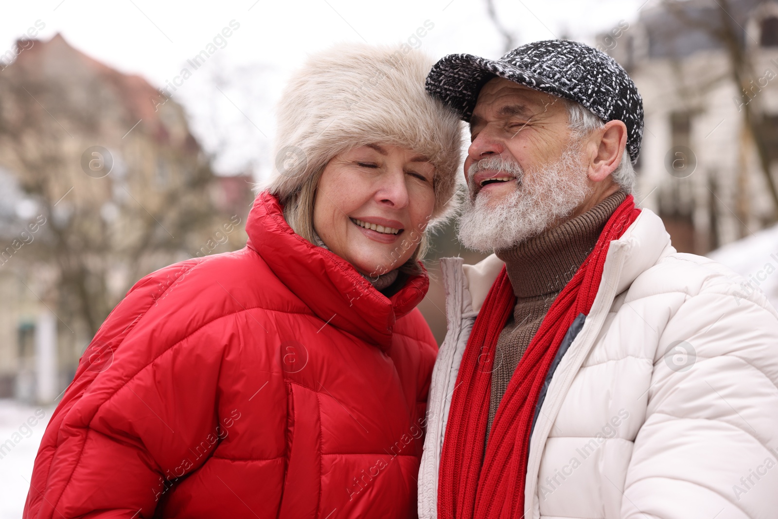 Photo of Lovely senior couple having fun on city street