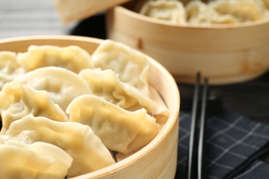 Photo of Tasty boiled gyoza (dumplings) on table, closeup