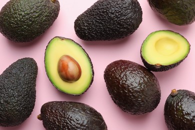 Photo of Fresh ripe avocados on pink background, flat lay