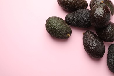 Photo of Fresh ripe avocados on pink background, flat lay. Space for text