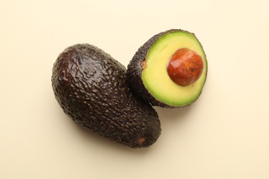 Photo of Fresh ripe avocados on beige background, top view