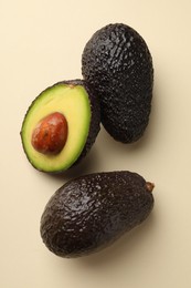 Photo of Fresh ripe avocados on beige background, flat lay