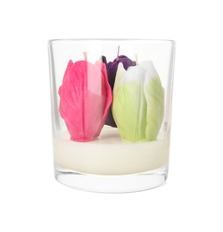 Photo of Beautiful flower-shaped candles in glass holder isolated on white