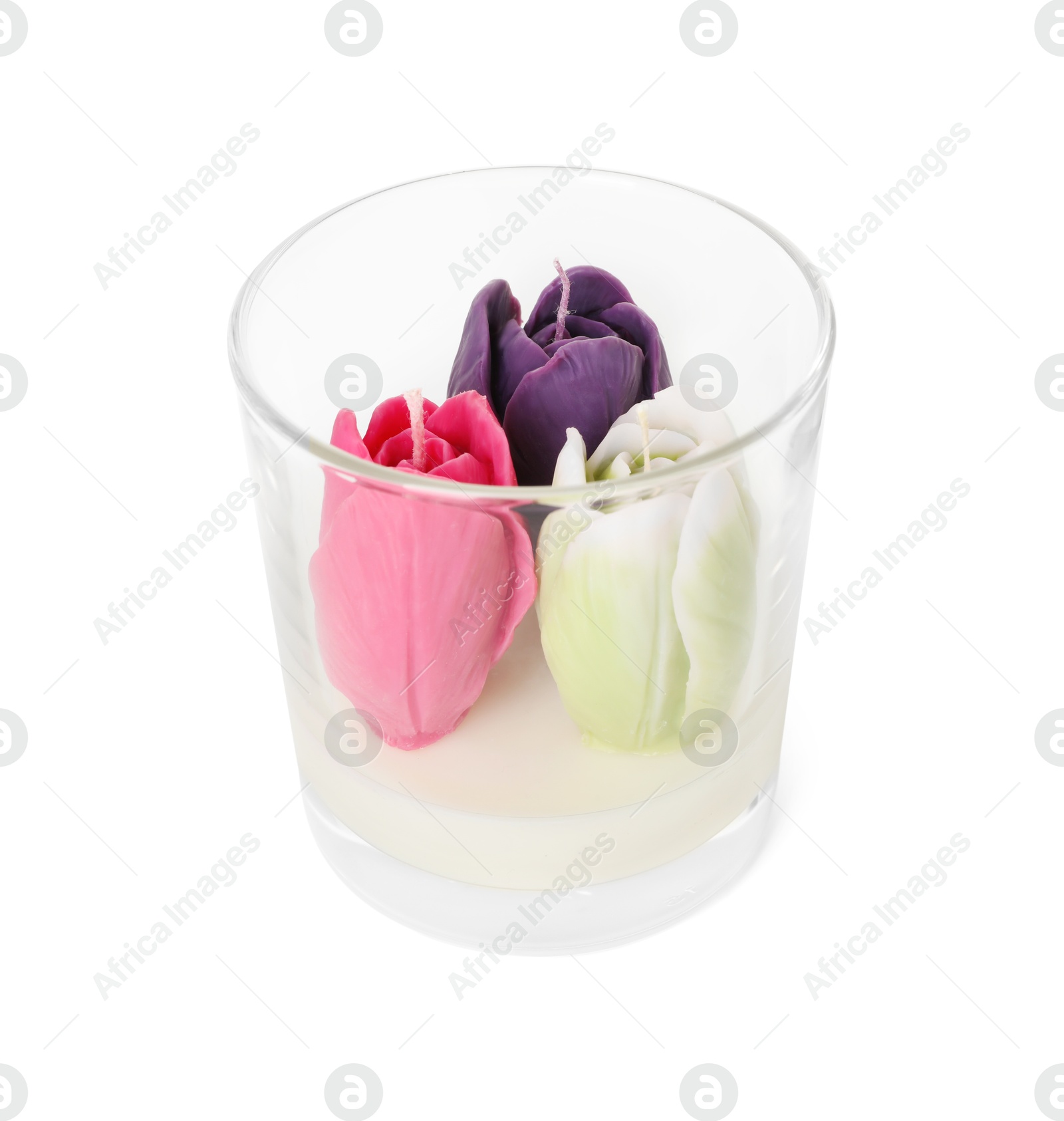 Photo of Beautiful flower-shaped candles in glass holder isolated on white