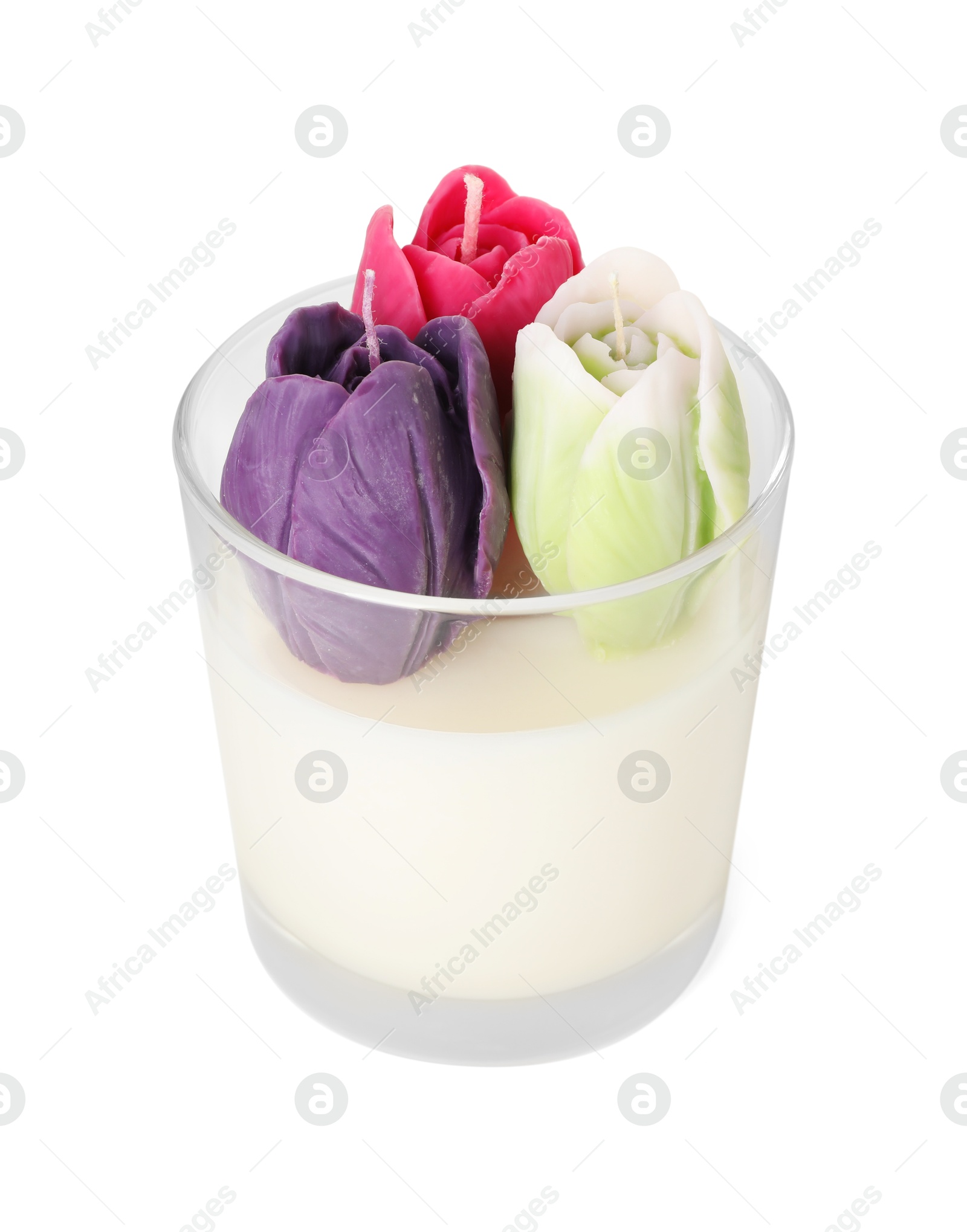 Photo of Beautiful flower-shaped candles in glass holder isolated on white