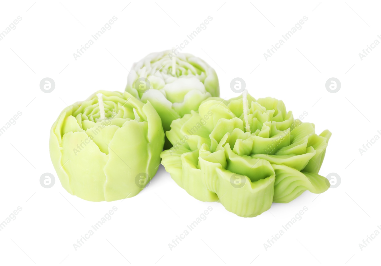 Photo of Beautiful green flower-shaped candles isolated on white