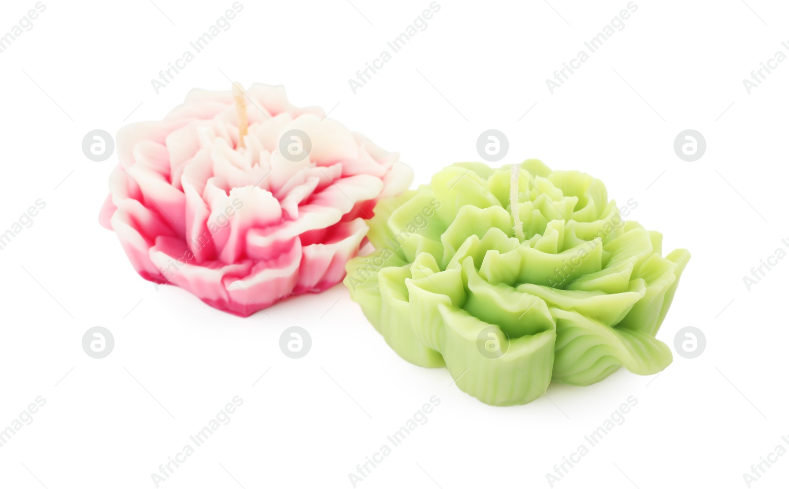 Photo of Two beautiful flower-shaped candles isolated on white