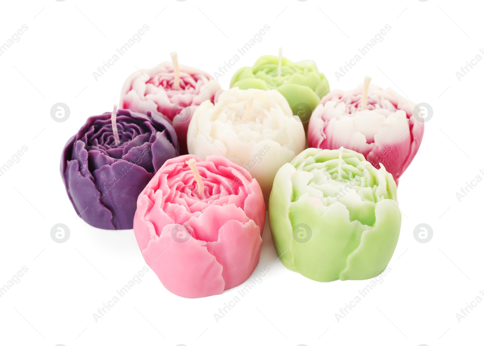 Photo of Many beautiful flower-shaped candles isolated on white