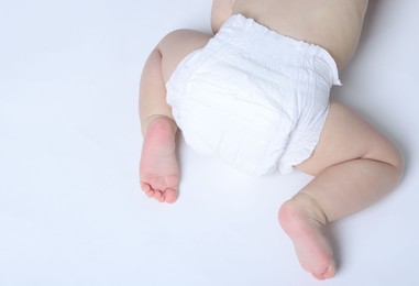 Photo of Little baby crawling on white background, top view. Space for text