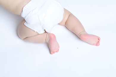 Photo of Little baby crawling on white background, top view. Space for text