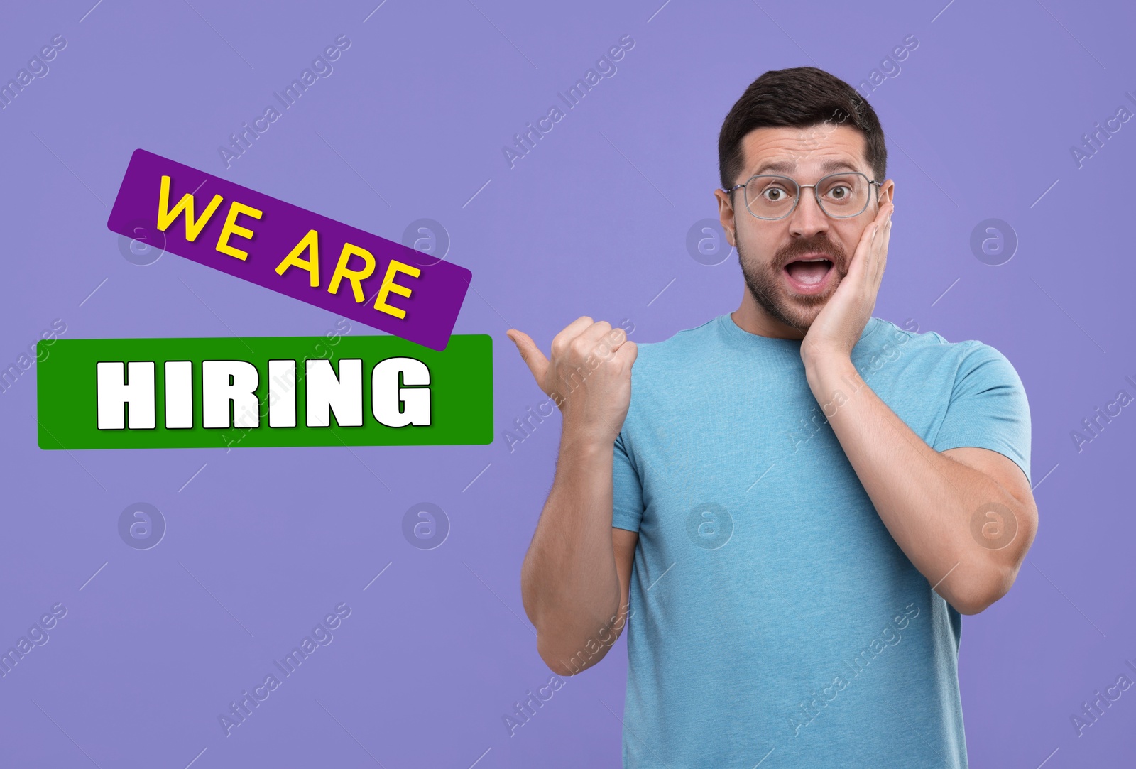 Image of Surprised man pointing at text We Are Hiring on violet background. Human resource, recruitment concept