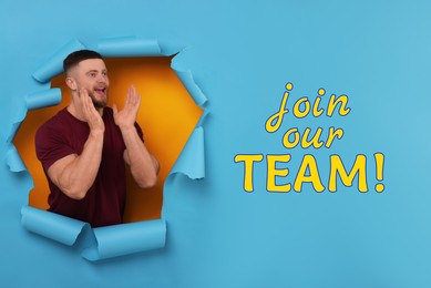 Image of Join our team! Young man shouting through hole in light blue paper. Human resource, recruitment concept