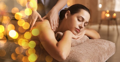 Woman receiving back massage in spa salon, bokeh effect. Banner design