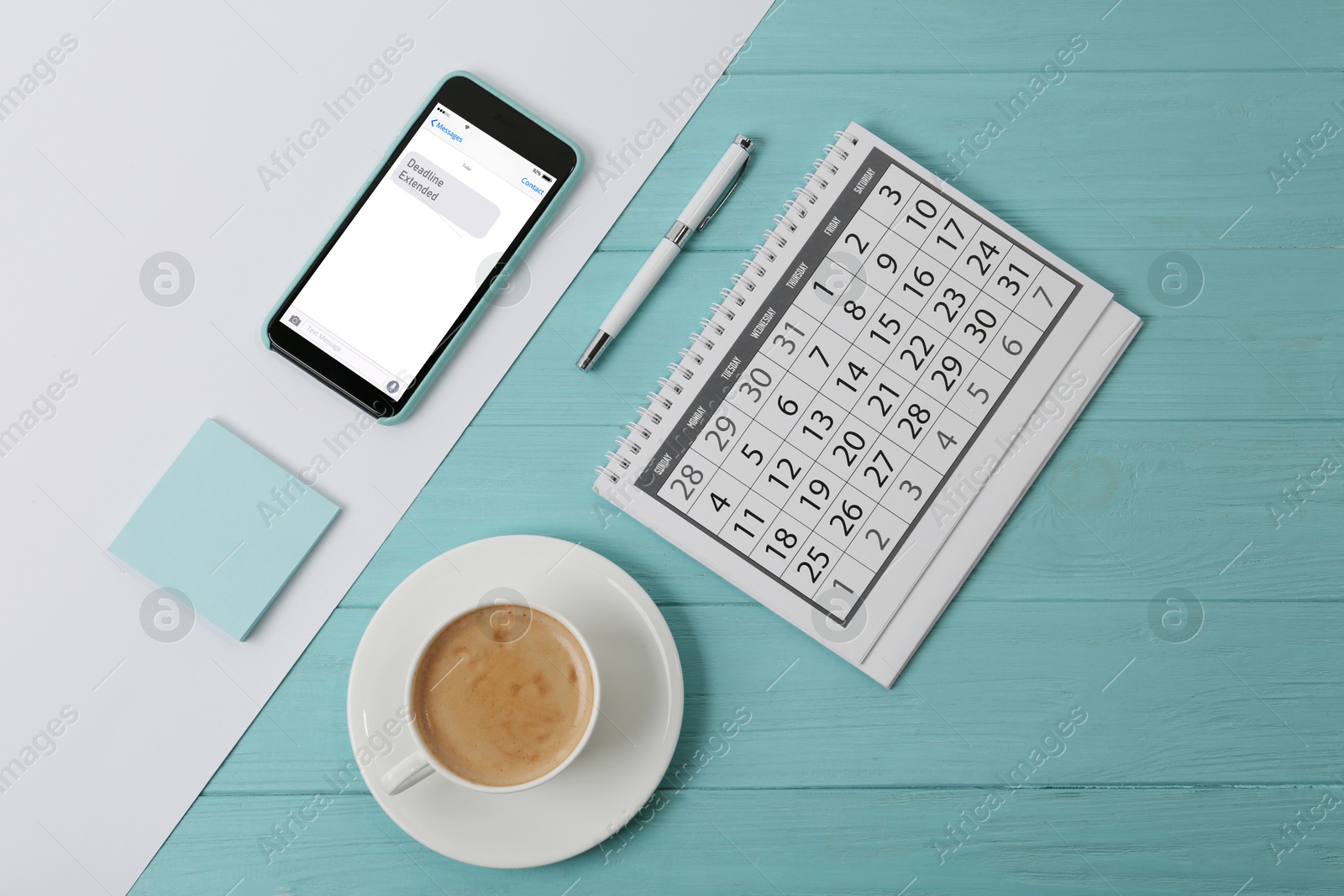 Image of Deadline Extended message on mobile phone screen. Calendar, pen, coffee, paper notes and gadget on color background, flat lay