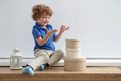 Photo of Little boy on window sill at home