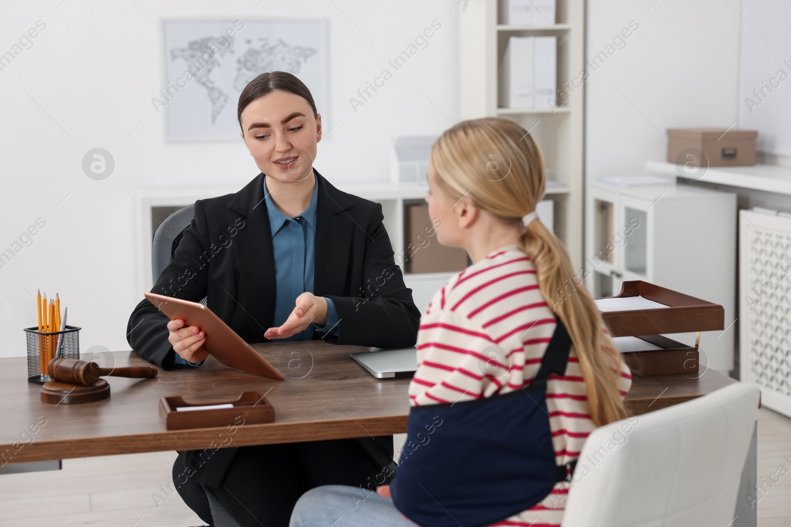 Photo of Injured woman having meeting with lawyer in office, selective focus