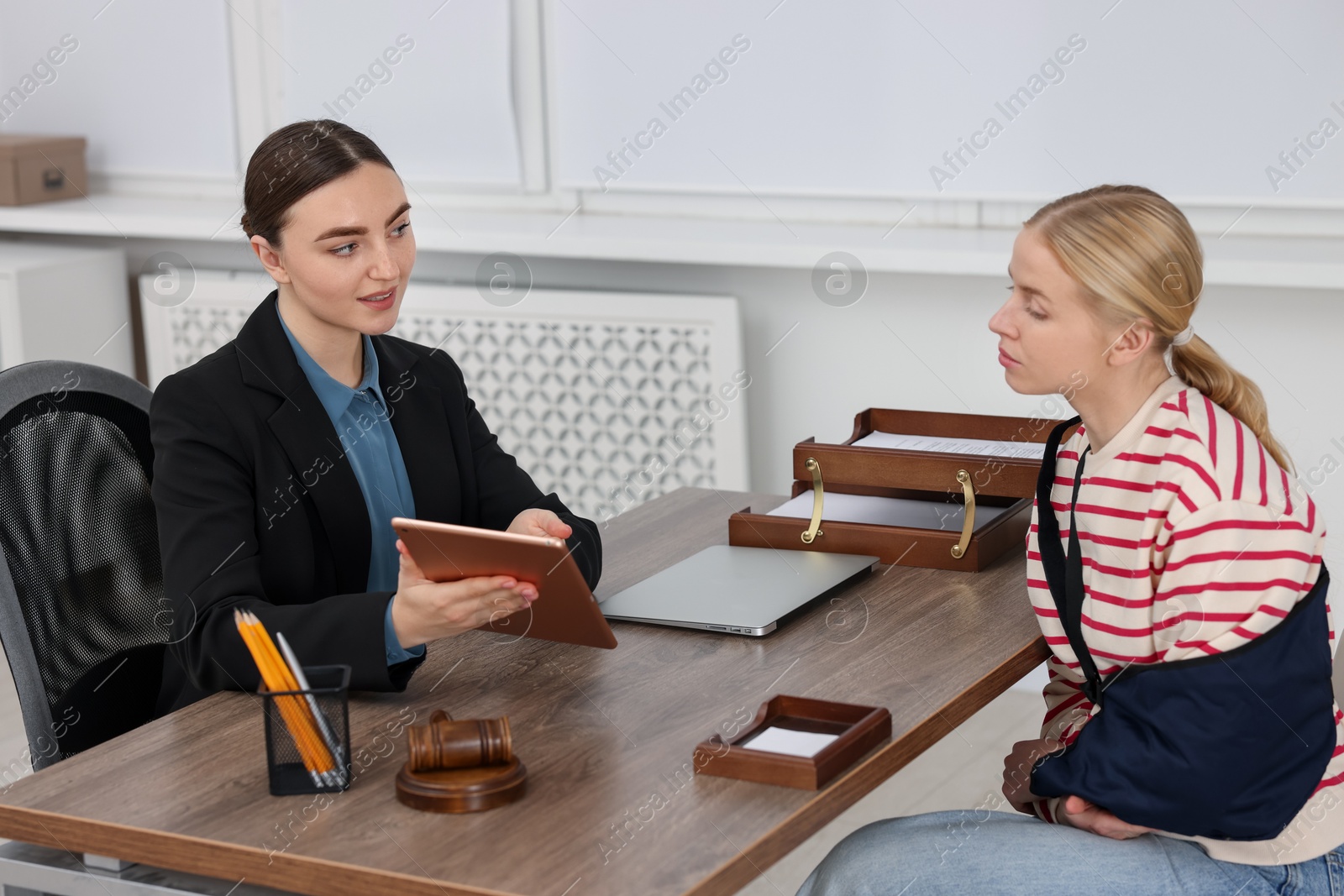 Photo of Injured woman having meeting with lawyer in office