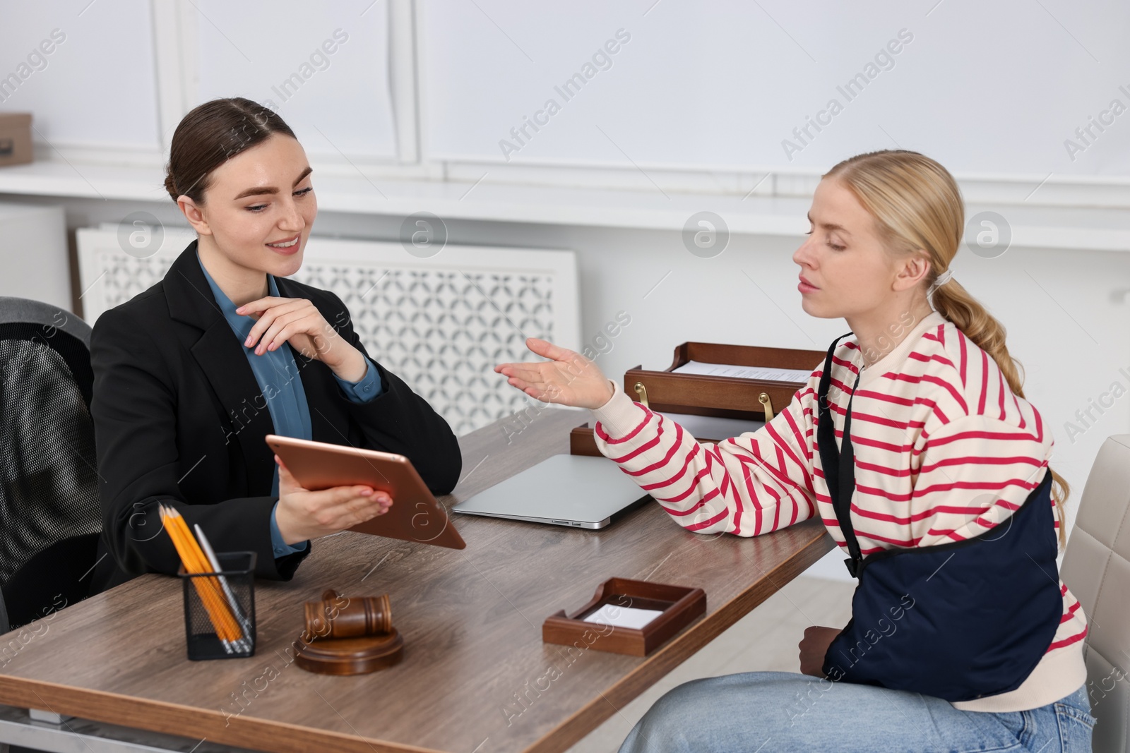 Photo of Injured woman having meeting with lawyer in office