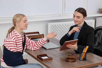 Photo of Injured woman having meeting with lawyer in office