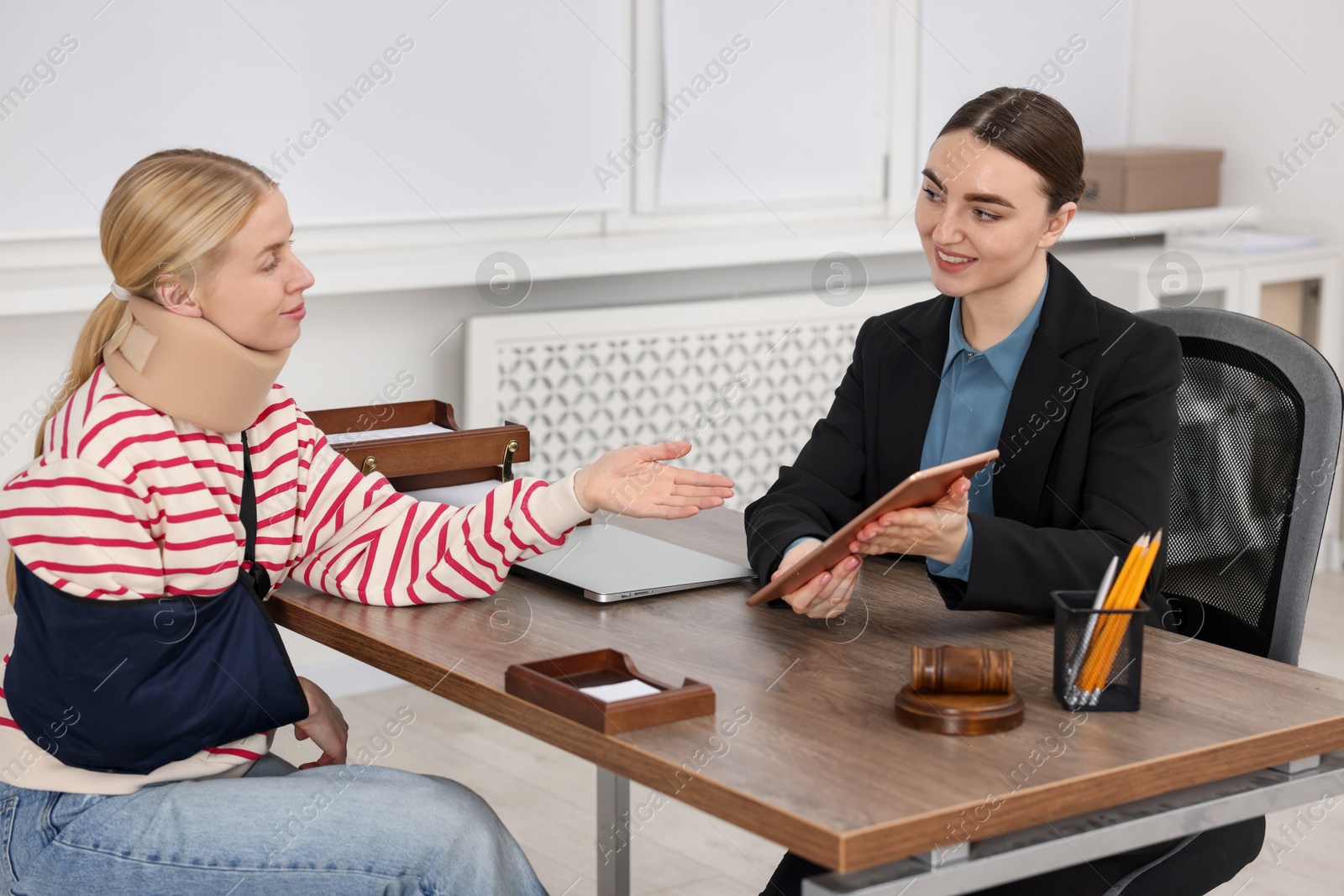 Photo of Injured woman having meeting with lawyer in office