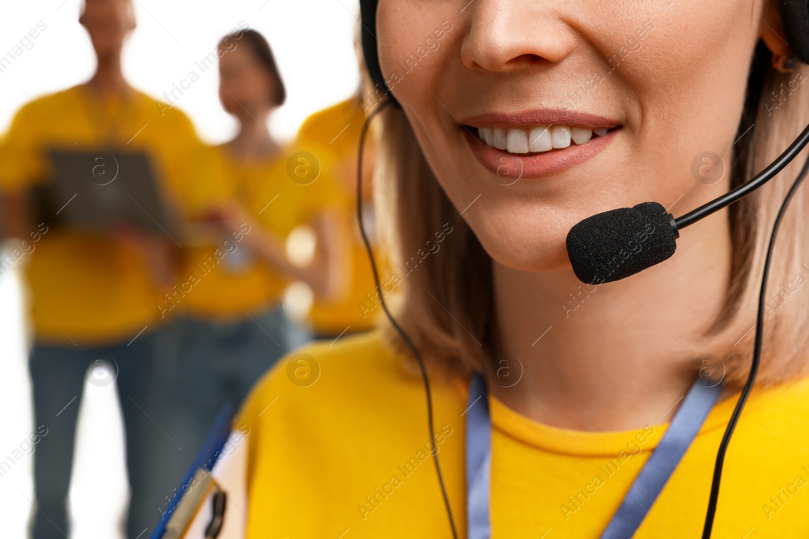 Photo of Technical support call center. Smiling operator on white background, closeup