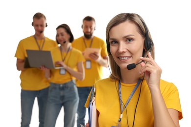 Photo of Technical support call center. Team of friendly operators on white background