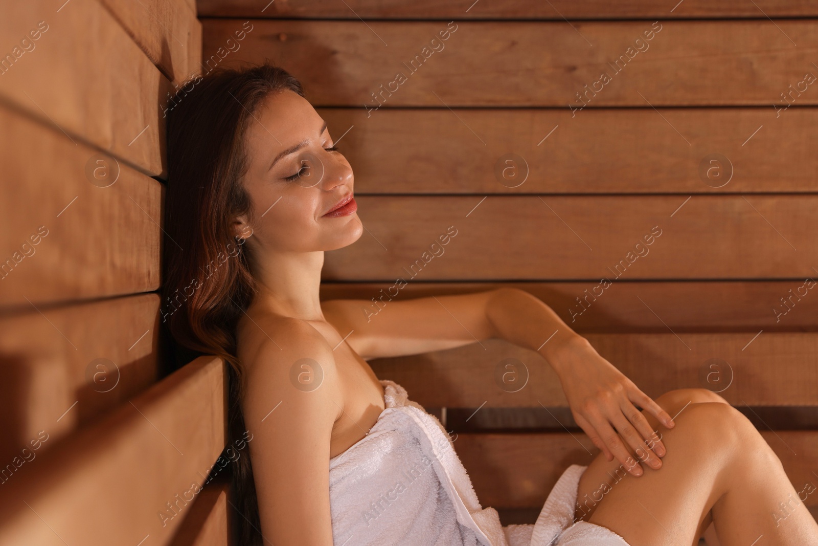 Photo of Beautiful woman relaxing at sauna. Space for text