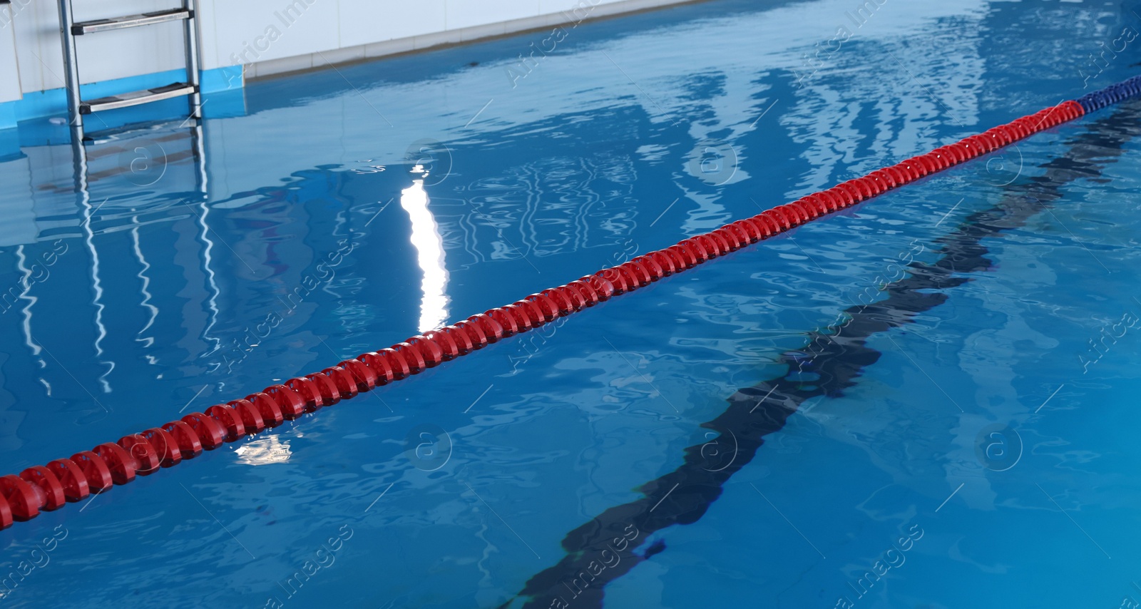 Photo of Swimming pool with clean water and lane dividers indoors