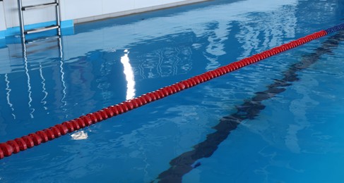 Photo of Swimming pool with clean water and lane dividers indoors