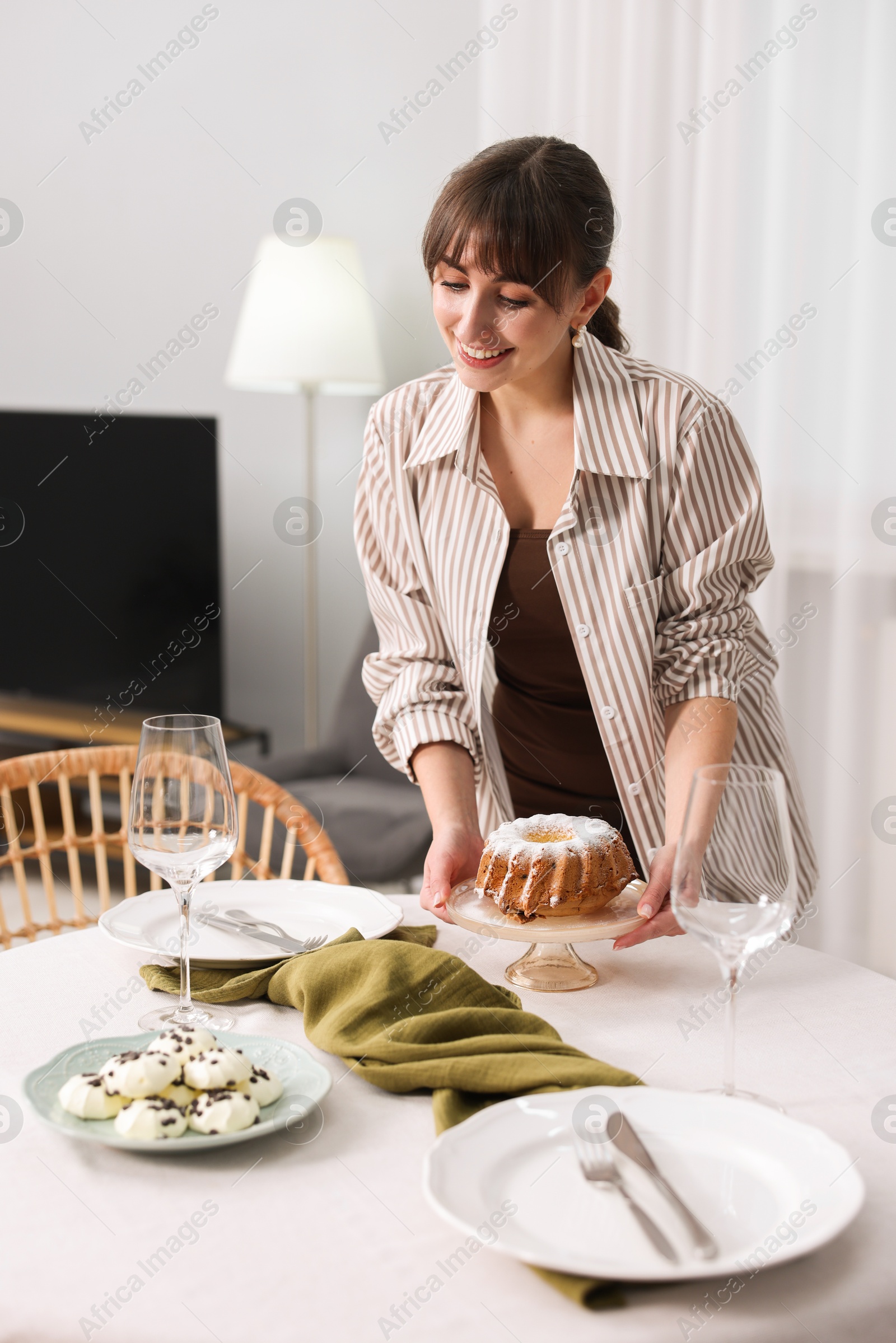 Photo of Woman setting table for dinner at home