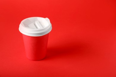 Photo of One paper cup on red background. Mockup for design